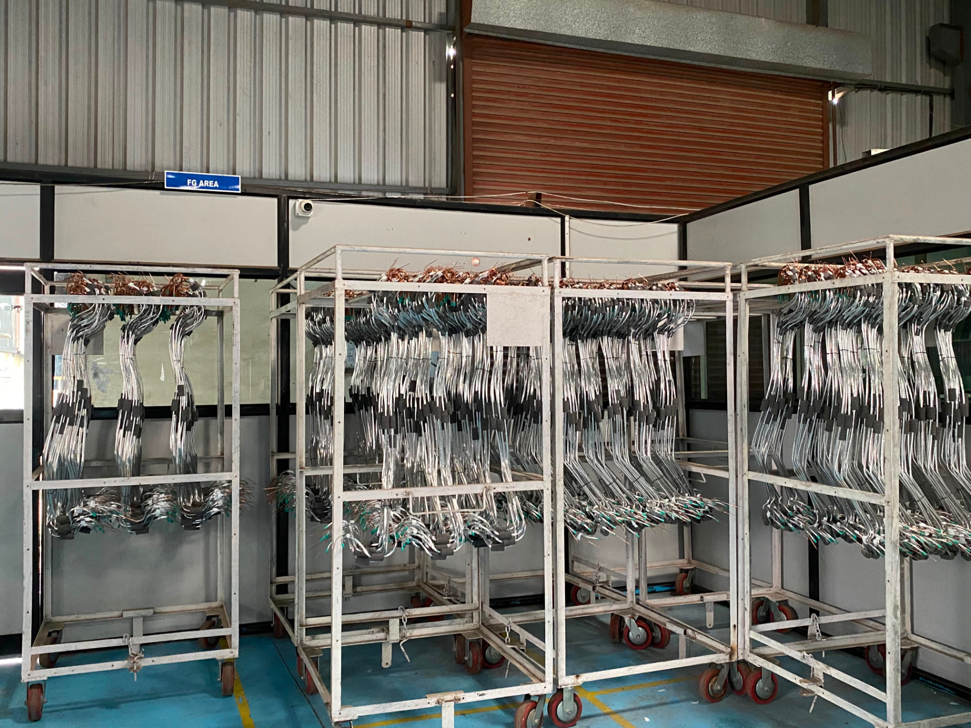 Finished goods area with trolleys of assembled copper suction and capillary pipe sets at E-Scedar India